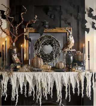 A fireplace mantel with Halloween decor