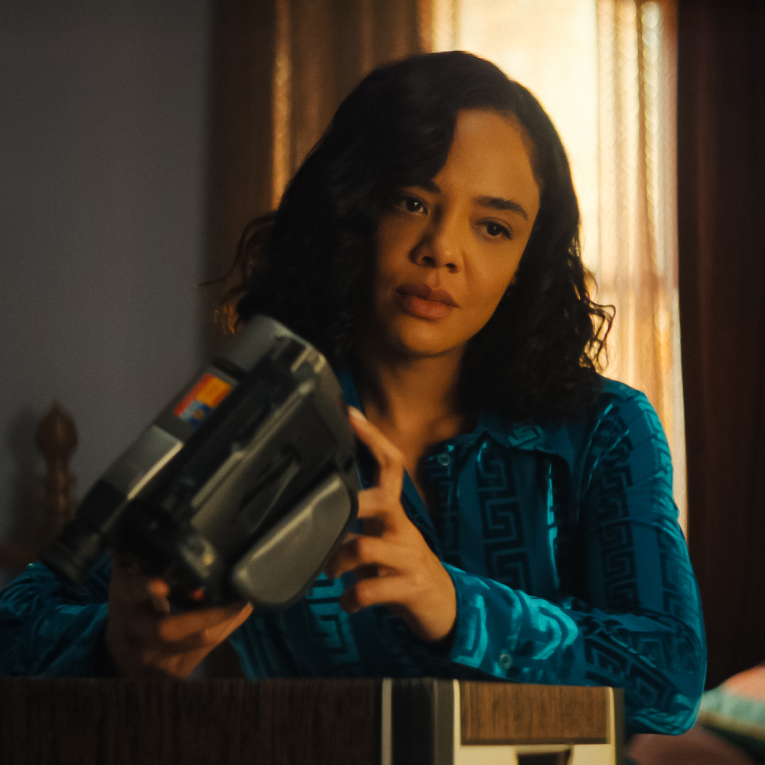 tessa thompson as anna looking at an old cam corder and its footage in a still from netflix's his and hers