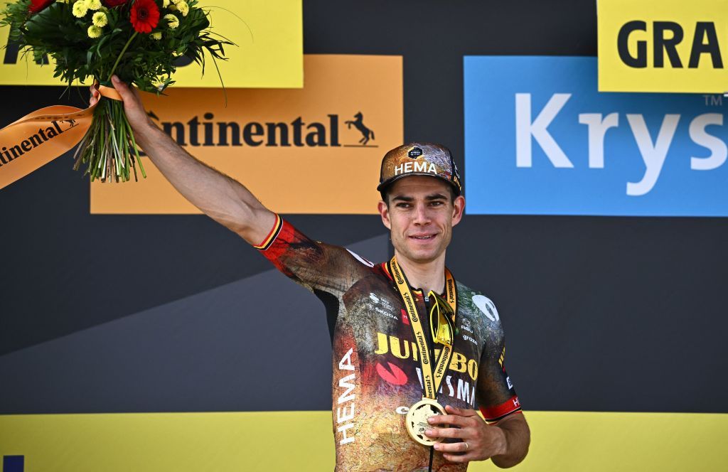 JumboVisma teams Belgian rider Wout Van Aert celebrates on the podium after winning the 4th stage of the 109th edition of the Tour de France cycling race 1715 km between Dunkirk and Calais in northern France on July 5 2022 Photo by AnneChristine POUJOULAT AFP Photo by ANNECHRISTINE POUJOULATAFP via Getty Images