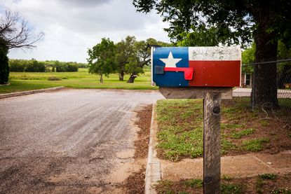 A mailbox painted with the Texas flag.