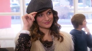Jenny Slate holding her hat on Parks and Recreation.