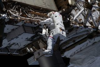 NASA astronaut Michael Hopkins works to ready the International Space station's port-side truss structure for future solar array upgrades during a spacewalk on Jan. 27, 2021.