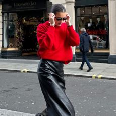 Influencer wears a leather pencil skirt.