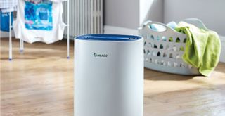dehumidifier with laundry in back ground