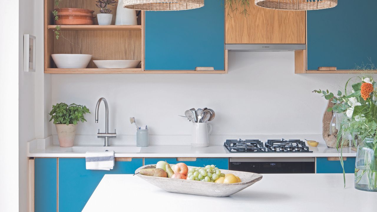 Kitchen with blue and oak cabinets and white kitchen island.