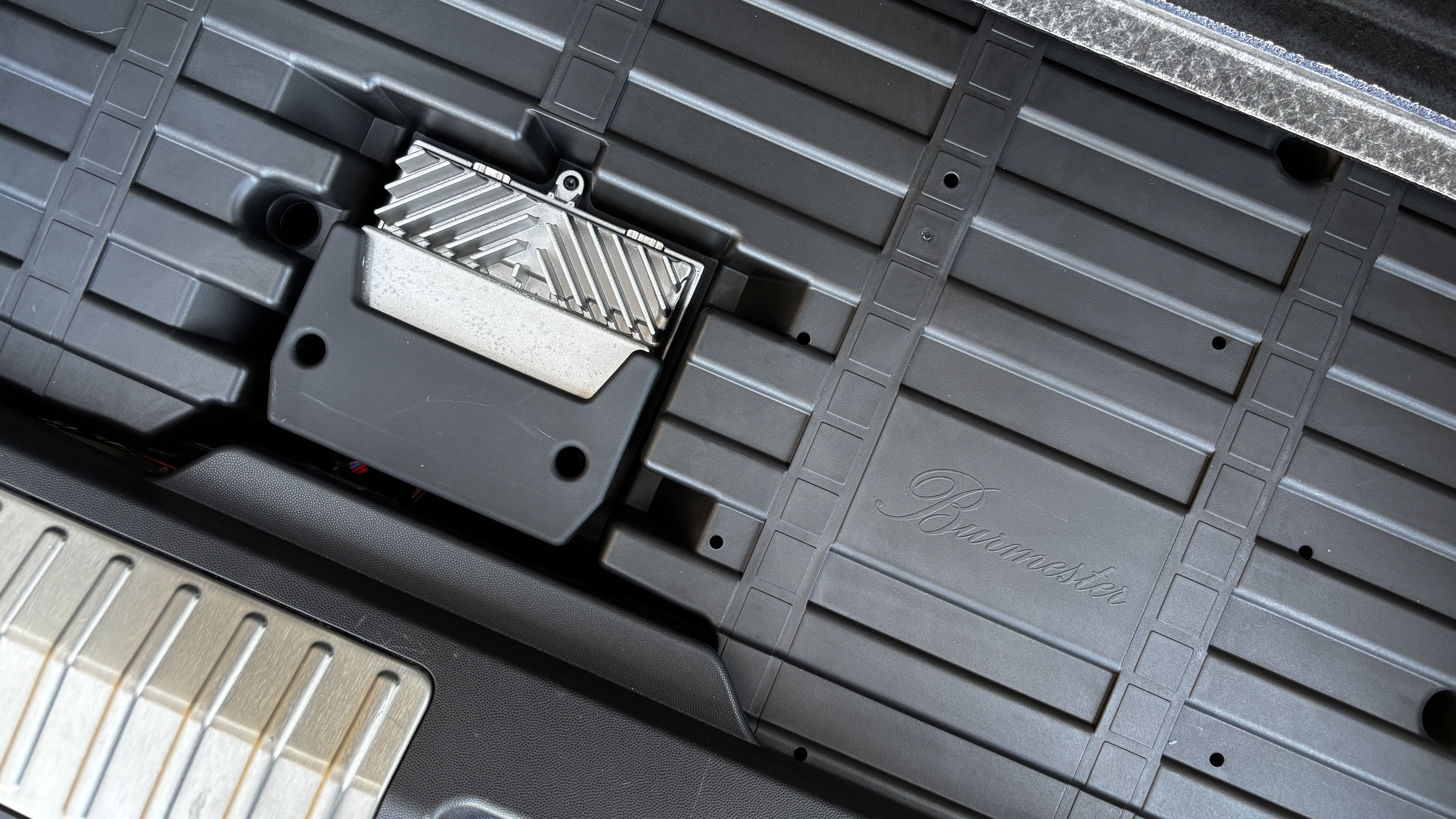 A subwoofer and amplifier in the rear of the Porsche Macan Electric
