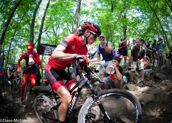 Lea Davison (Specialized) being chased by a devil with a megaphone