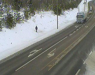 Tatu Gustafsson standing on a snowy verge taken by a weather camera