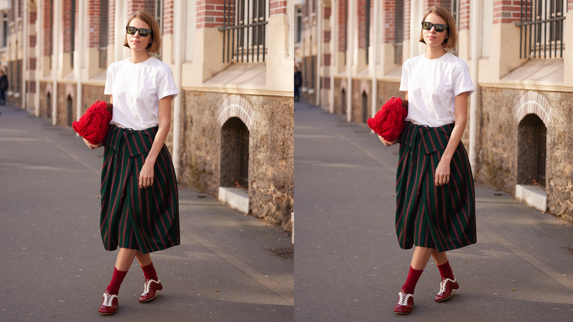 Woman wears whit tee and plaid skirt and a red clutch. 