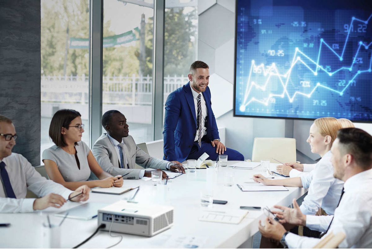 Business people at meeting with display screen 