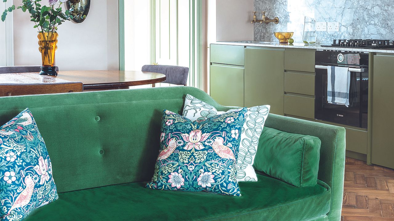 Green kitchen with green velvet sofa