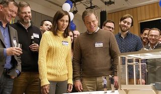 Downsizing Kristen Wiig Matt Damon looking at a shrunken couple