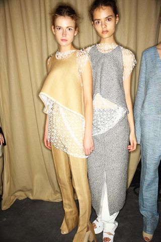 Models wearing abstract curved form clothing