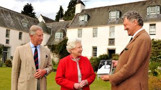 Queen Elizabeth II with Prince Charles, Prince of Wales is presented with one of the first copies of 'Queen Elizabeth the Queen Mother, The Official Biography'