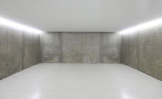 Empty room displaying concrete walls, floor and ceiling