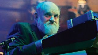 English composer Robert John Godfrey performing live on stage with symphonic rock group The Enid at Birmingham Symphony Hall, accompanied by a 200-piece choir and the City Of Birmingham Symphony Orchestra, taken on October 15, 2011. (Photo by Mark Howell/Classic Rock Magazine/Future Publishing via Getty Images)