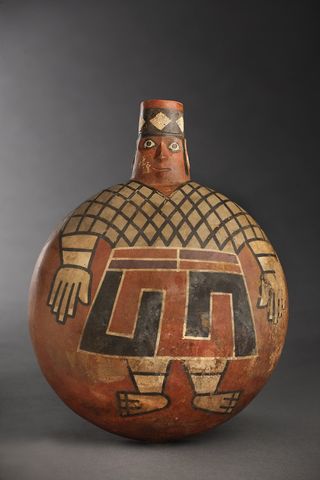 With eyes wide open, a painted Wari lord stares out from the side of a 1,200-year-old ceramic flask found in a newly discovered tomb at El Castillo de Huarmey in Peru. The Wari forged South America's earliest empire between A.D. 700 and 1000.