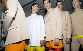 Males modelling beige jackets and shorts