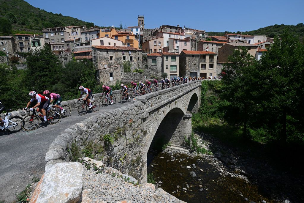 LES ANGLES FRANCE JUNE 18 A general view of Andr Rodrigues De Carvalho of Portugal and Team Cofidis Ben Healy of Ireland and Team EF Education Easypost Szymon Sajnok of Poland and Team Cofidis and the peloton compete passing through Pesilhan de Conflent village landscape during the 46th La Route dOccitanie La Depeche du Midi 2022 Stage 3 a 1887km stage from Sigean to Les Angles 1841m RDO2022 on June 18 2022 in Les Angles France Photo by Dario BelingheriGetty Images