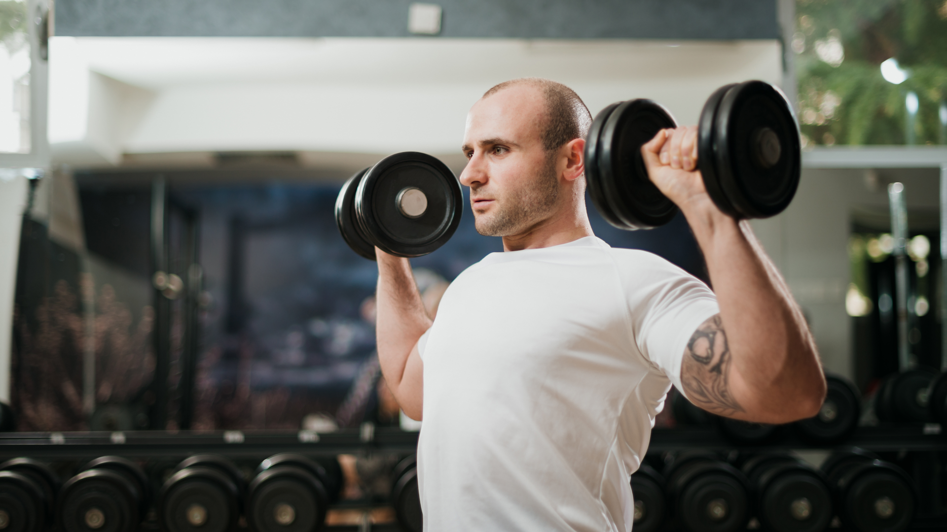 A man doing dumbbell shoulder press