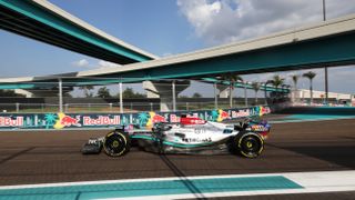 The silver Mercedes F1 car swoops around a bend at the sunny Miami Grand Prix