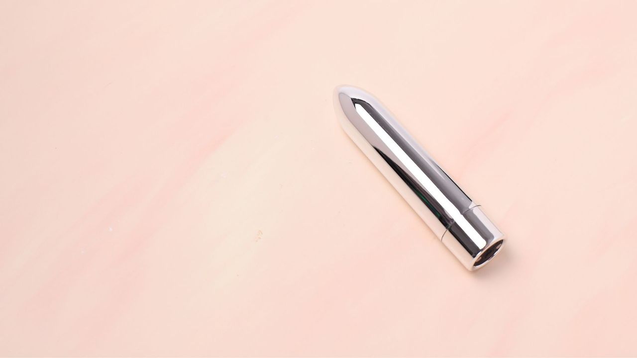 Silver bullet vibrator lying flat, representing how to use a bullet vibrator