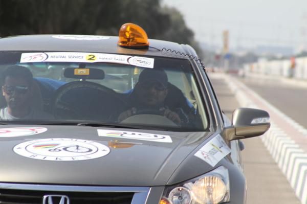 A support vehicle drives behind the race