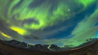 Astrophotographer Miguel Claro captured this spectacular vertical panorama or the aurora borealis from the Arctic Circle. Can you see the shape of a bird flying with a running rabbit?