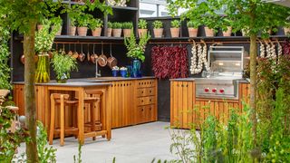 Outdoor kitchen ideas with wooden units and stainless steel grill