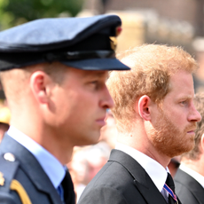 Prince William, Prince of Wales and Prince Harry, Duke of Sussex walk behind the coffin during the procession for the Lying-in State of Queen Elizabeth II on September 14, 2022 in London, England.