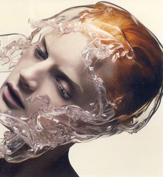A portrait of a woman depicting the water cascading down her hair and face.
