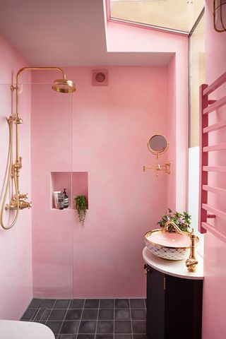 A bright pink stone shower enclosure