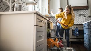 Quietest dishwashers: Two girls loading the dishwasher