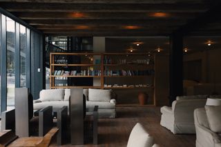 Lounge area with bookshelves at the Rooms Hotel Kokhta