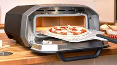 one of the best indoor pizza ovens, the Ooni Volt 12, loaded with a pizza