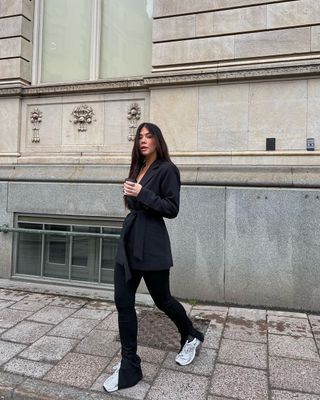 @cassklatzkow wearing split-hem leggings with trainers and blazer