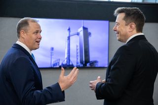 NASA administrator Jim Bridenstine (left) and SpaceX founder and CEO Elon Musk (right) chat before SpaceX's Falcon 9 rocket lifts off for the Crew Dragon in-flight abort test on Jan. 19, 2020.