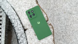 The Moto G Power 2025 face down in snow