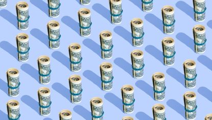 Repeated rolls of American dollars on a blue background