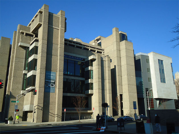 A street level view of Rudolph Hall, a large concrete block building.