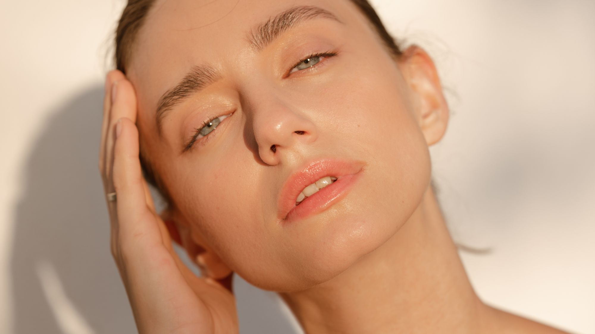 Close-up image of a woman with hydrated skin in the sunlight