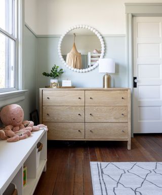 Children's room painted in a muted green paint color and paired with a classic white on the ceiling and upper part of the walls
