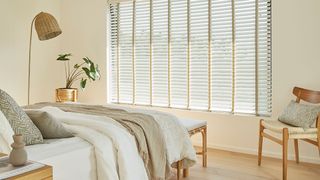 small bed with wooden bed and cream venetian blinds