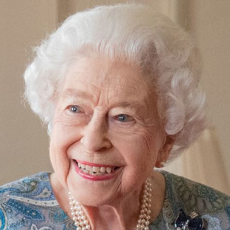 Queen Elizabeth II in a blue dress smiling