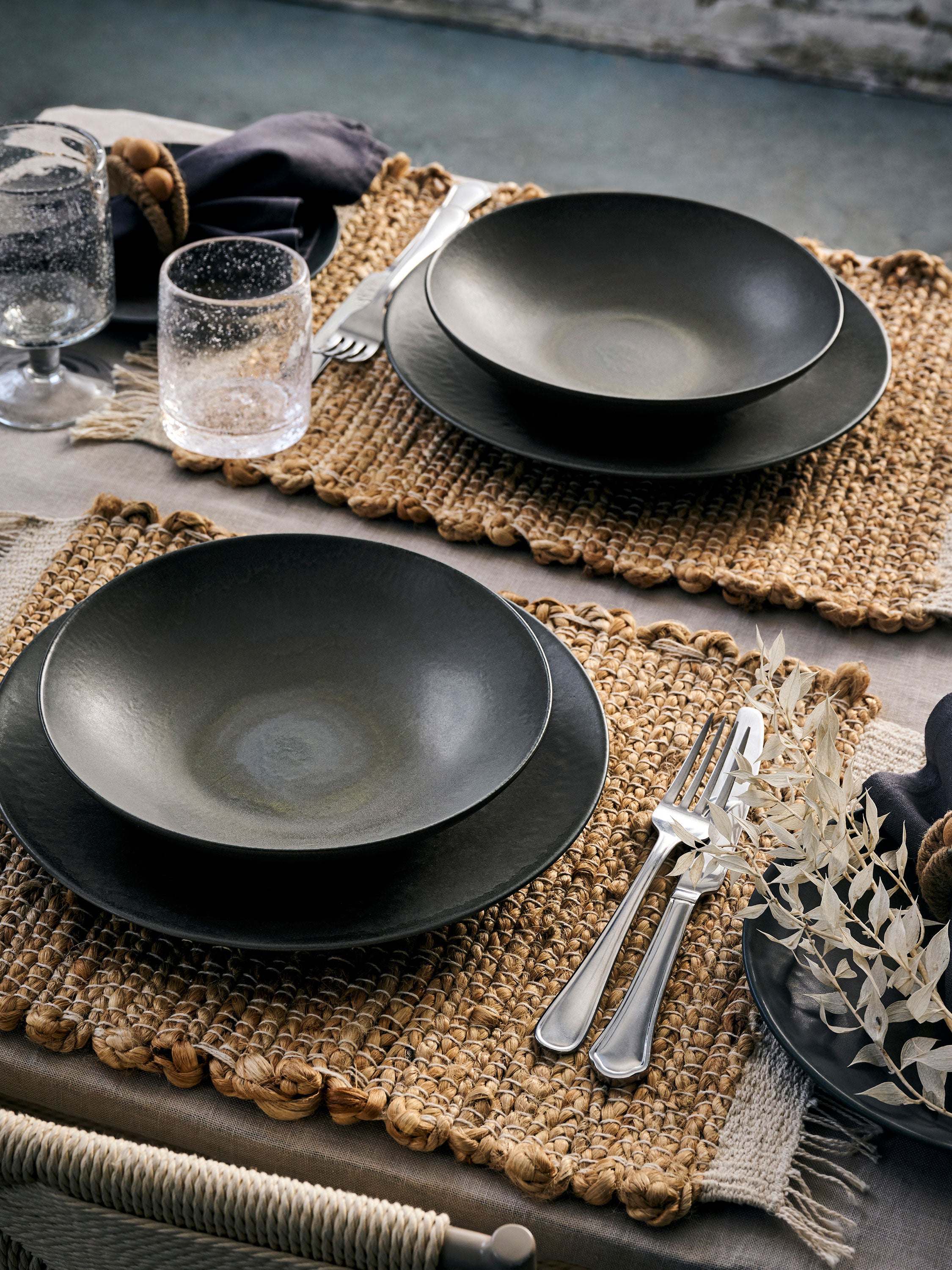 a dinner set on a set table with rattan tableware