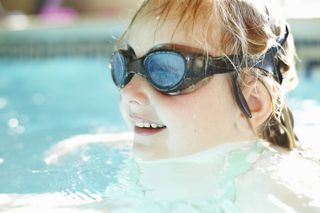 Close up of girl swimming in an open swimming pool