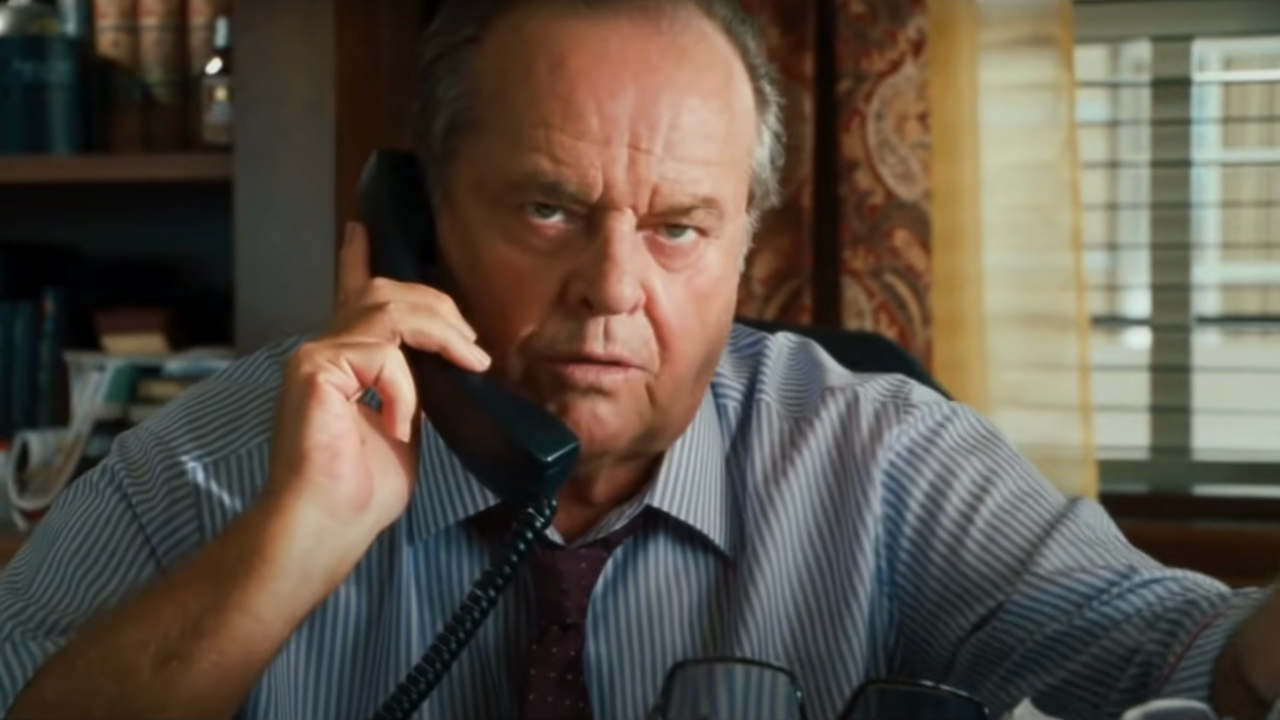 Jack Nicholson sits with an upset look on his face while on a phone call in How Do You Know.