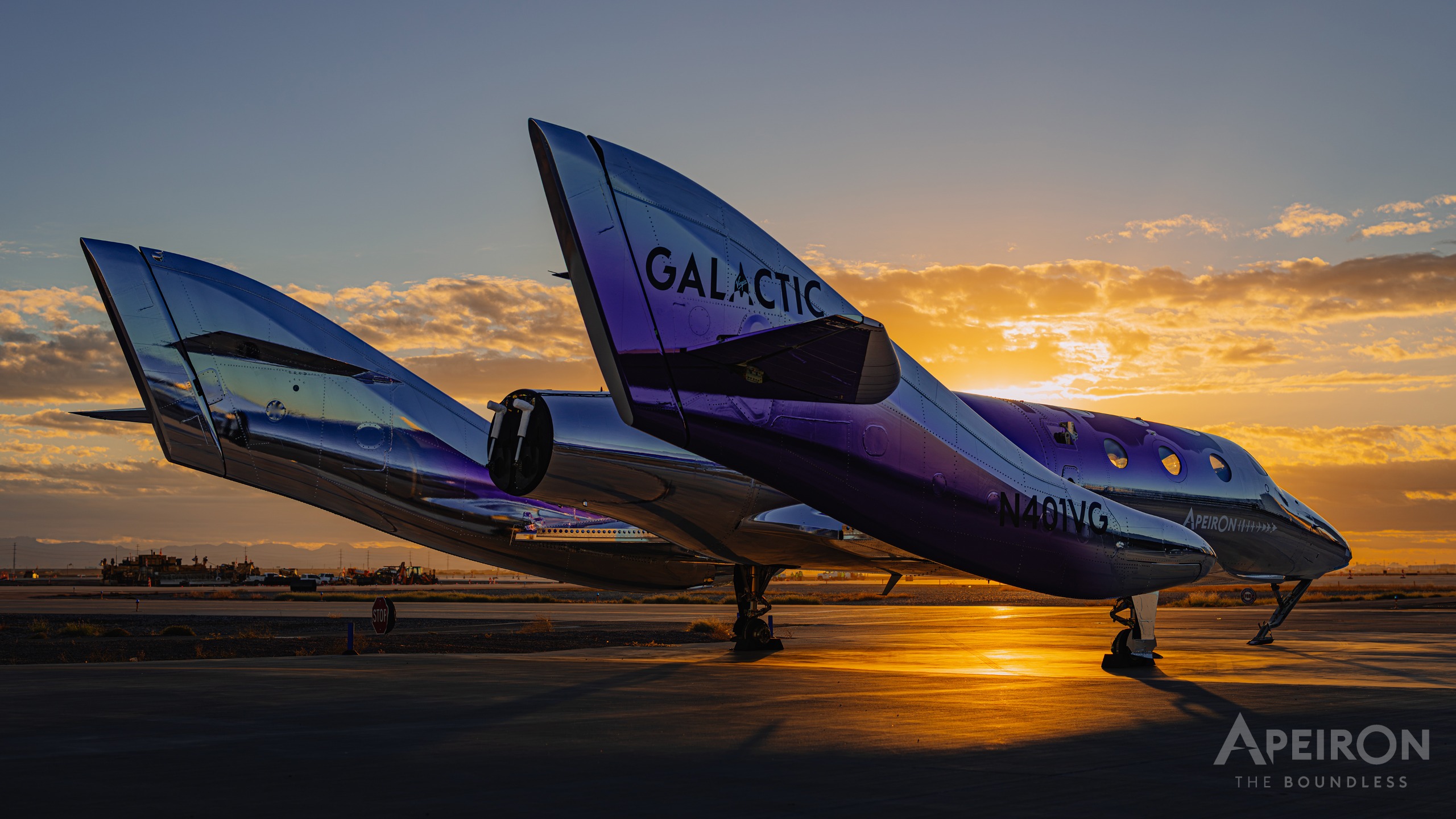 A shiny purple space plane stands on a runway slightly silhouetted by a setting sun.