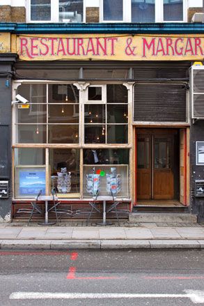 Outside Gopher Hole gallery, home to the current Project Heracles exhibition. A street shop with glass windows and a wooden door.