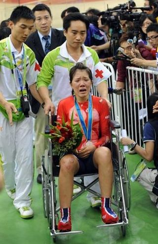Women's points race silver medalist Wan Yiu Wong (Hong Kong, China), who crashed during the final while leading on points, is taken from the podium via wheelchair.